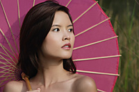 Woman with pink parasol - Asia Images Group