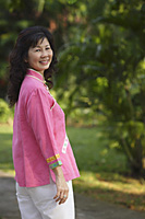 Woman in park, smiling at camera - Asia Images Group