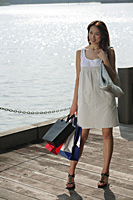 Young woman carrying shopping bags - Asia Images Group