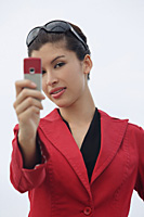 Woman taking picture with mobile phone - Asia Images Group
