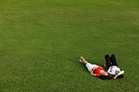 Two women relaxing in the park - Asia Images Group