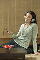 Young woman listening to music - Asia Images Group