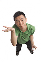 Man shrugging while looking at camera - Asia Images Group