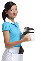 Waitress smiling at camera, pouring coffee - Asia Images Group