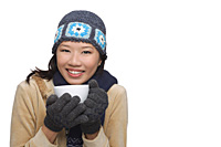Woman freezing and smiling at camera - Asia Images Group