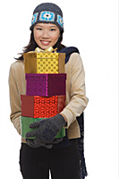 Young woman with gift boxes, smiling at camera - Asia Images Group