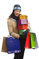 Young woman with gift boxes and shopping bags, smiling at camera - Asia Images Group