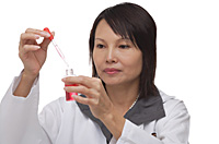 Scientist holding pipette and flask - Asia Images Group