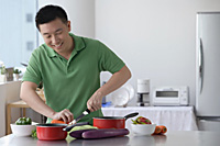Man cooking in the kitchen - Asia Images Group