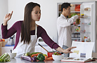 Young couple cooking in the kitchen - Asia Images Group