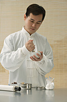 Doctor experimenting with traditional Chinese medicine - Asia Images Group