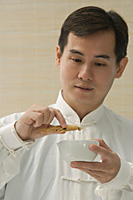 Doctor experimenting with traditional Chinese medicine - Asia Images Group