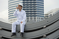 Man with walkie talkie giving directions - Asia Images Group