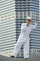 Man with walkie talkie giving directions - Asia Images Group