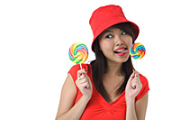 Young woman licking on lollipop - Asia Images Group