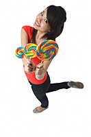 Young woman with lollipop smiling at camera - Asia Images Group