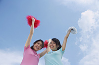 Young woman cheerleading with pom poms - Asia Images Group