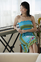 Young woman relaxing at keyboard - Asia Images Group