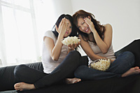 Young women enjoying popcorn - Asia Images Group