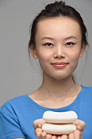 Young woman with soap smiling at camera - Asia Images Group