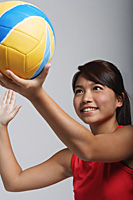 Young woman playing with volleyball - Asia Images Group