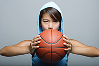 Young woman with basketball looking at camera - Asia Images Group
