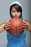 Young woman with basketball looking at camera - Asia Images Group