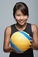 Young woman with volleyball smiling at camera - Asia Images Group