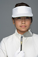 Young woman in golfing outfit looking at camera - Asia Images Group