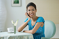 Young woman sitting in restaurant - Asia Images Group
