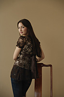 Young woman looking over shoulder at camera - Asia Images Group