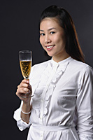Young woman toasting with champagne and looking at camera - Asia Images Group