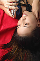 Young woman with perfume lying down - Asia Images Group