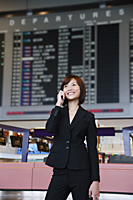 Young woman with mobile phone at the airport - Asia Images Group