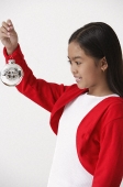 Girl holding up Christmas decoration - Asia Images Group