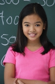 Girl standing in front of blackboard - Asia Images Group