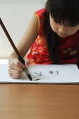 Young girl practicing calligraphy - Asia Images Group