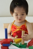 Baby girl playing with building blocks - Asia Images Group