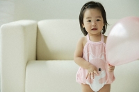 Baby girl with balloon - Asia Images Group