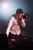 Young man working as DJ - Asia Images Group