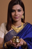 Indian woman holding offering - Asia Images Group