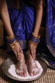 Indian woman with feet in salt scrub - Asia Images Group