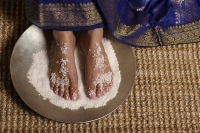 Indian woman's feet in salt scrub - Asia Images Group