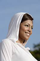 woman wearing hooded sweater, smiling - Asia Images Group