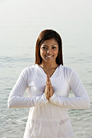 woman practicing yoga at the beach - Asia Images Group