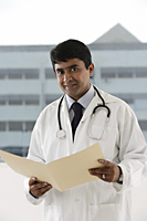 doctor holding patient file - Asia Images Group