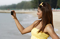 Side view of woman taking a picture - Asia Images Group
