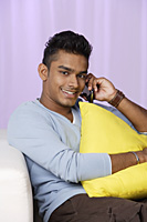 young man talking on mobile phone, relaxed - Asia Images Group