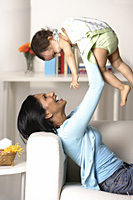woman holding baby in the air - Asia Images Group