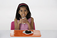 Girl with milk and cookies - Asia Images Group